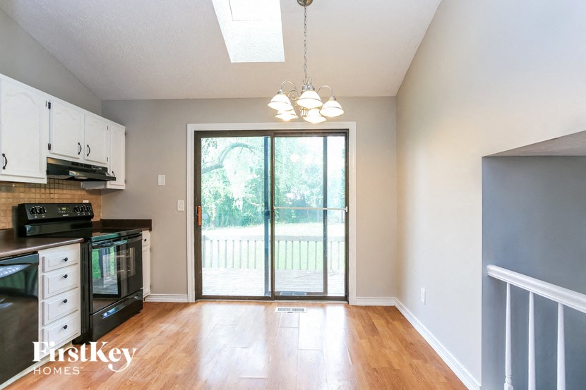an empty kitchen with a sliding glass door to a patio