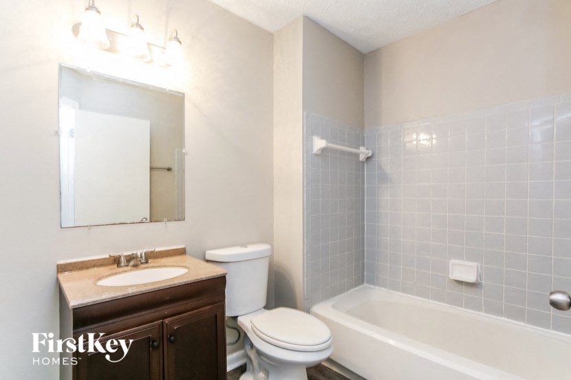 a bathroom with a sink toilet and a bath tub