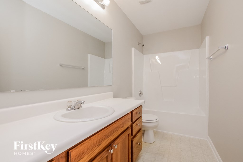a bathroom with a sink and a toilet and a shower