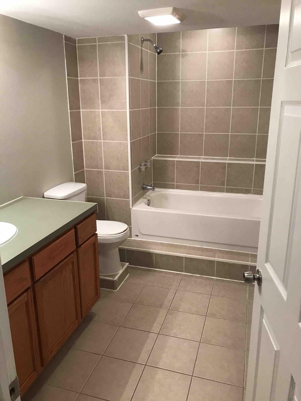 a bathroom with a toilet and a tub and a sink