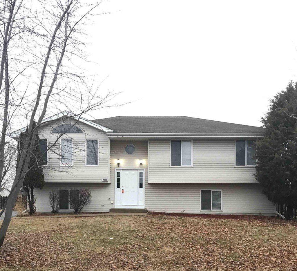 a white house with a white door and a yard