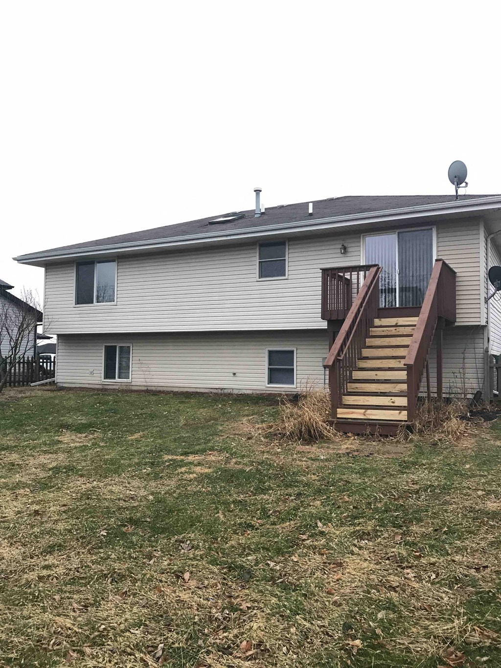 a house with a porch and stairs in a yard