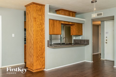 a kitchen with wooden cabinets and a counter top and a sink
