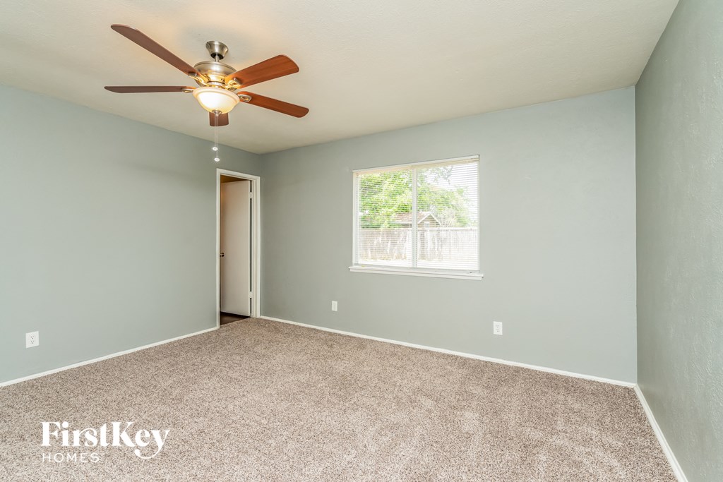 the master bedroom is spacious and has a ceiling fan