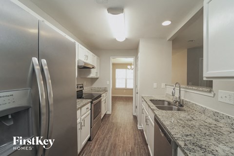 a kitchen with marble counter tops and stainless steel appliances