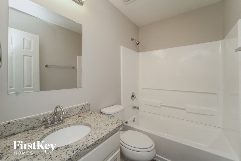 a bathroom with a sink toilet and a bath tub
