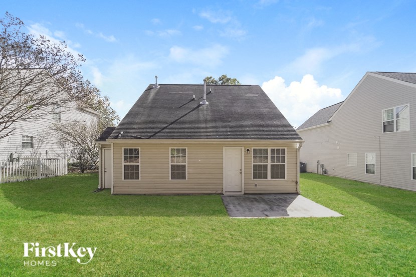 the back of a house with a yard and a garage