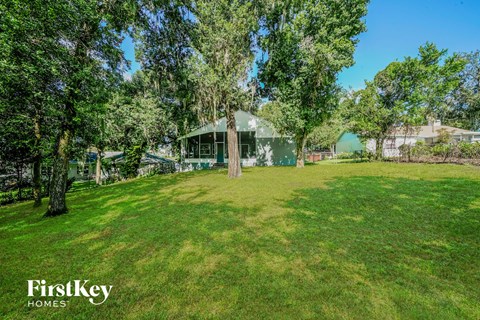 a green house sitting in the middle of a grass field