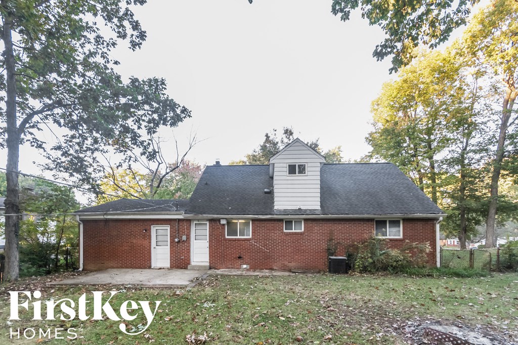 front view of a brick house with a gray roof