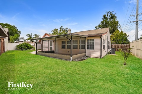 a backyard with a small house and a yard with grass