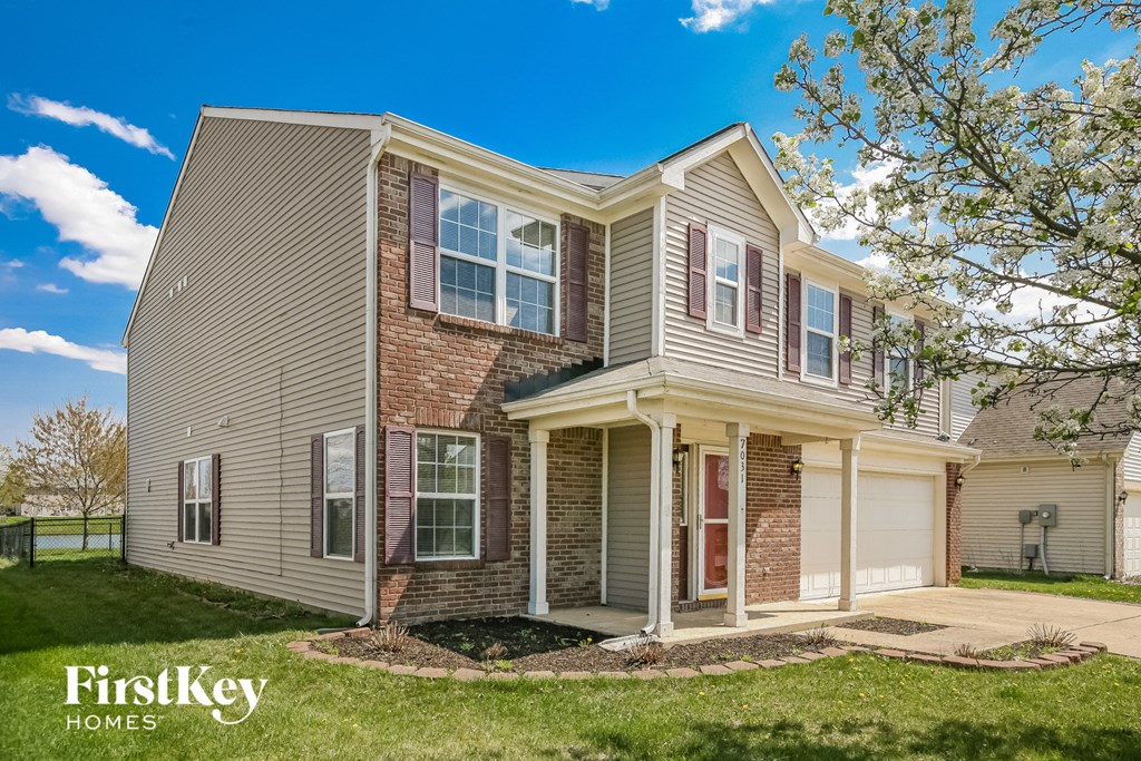 A two-story house with a garage is for sale by FirstKey Homes.