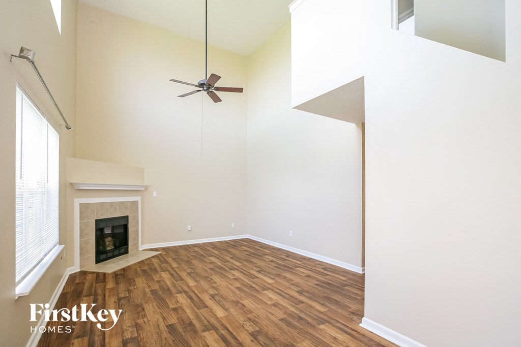 A room with a fireplace and a fan.