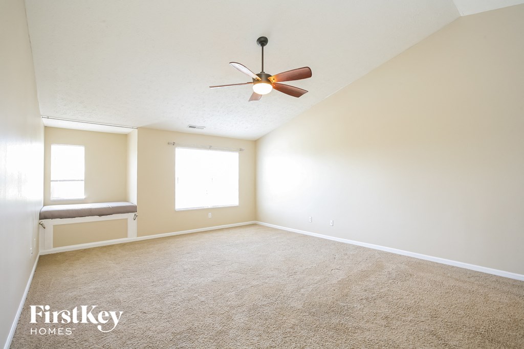 A room with a fan and a window.