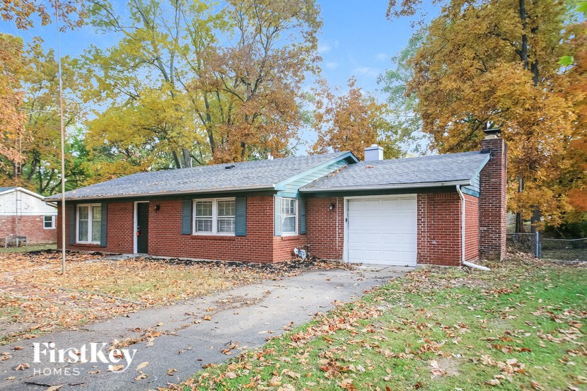 front view of a brick house with a white garage door