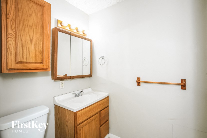 a bathroom with a sink and a mirror and a toilet