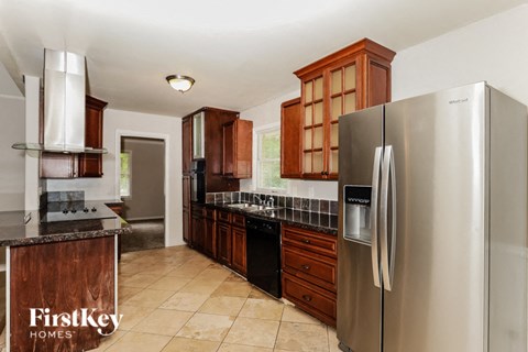 a kitchen with stainless steel appliances and wooden cabinets