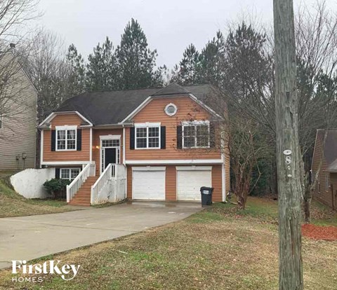 a brick house with a garage and a driveway