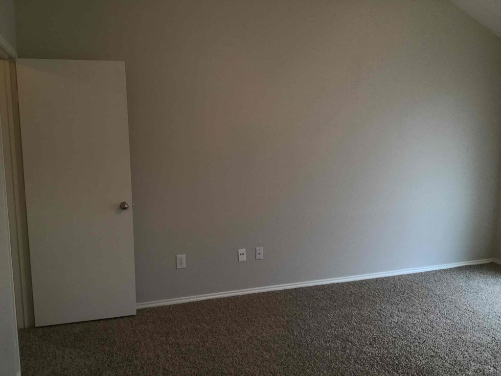 a room with a white wall and a door