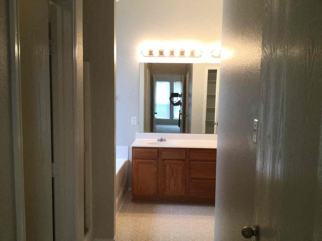 a view of a bathroom with a sink and a mirror