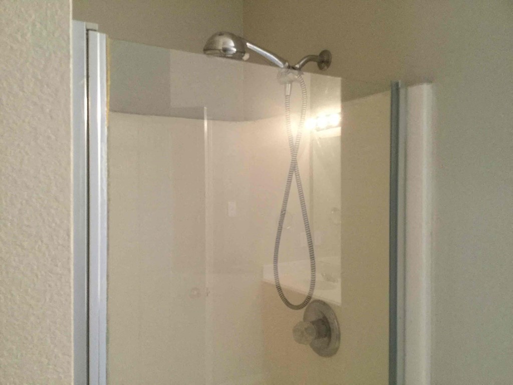 a shower in a bathroom with a glass door
