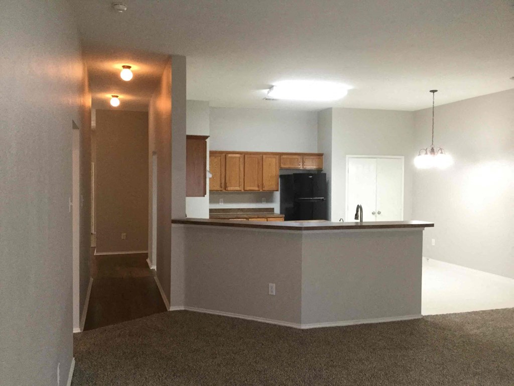 an empty kitchen with an island in the middle of it