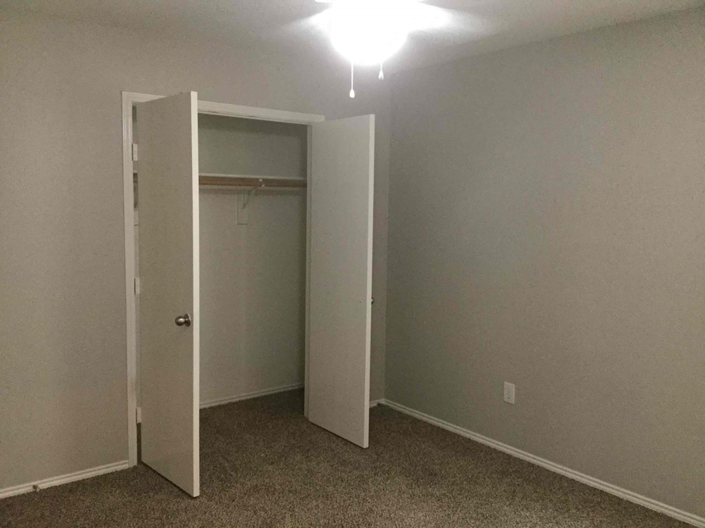 a room with a closet and an open door