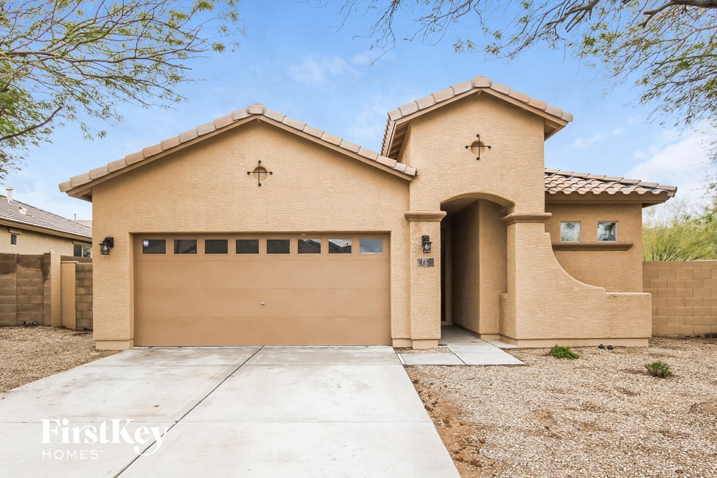 a tan brick house with a garage door