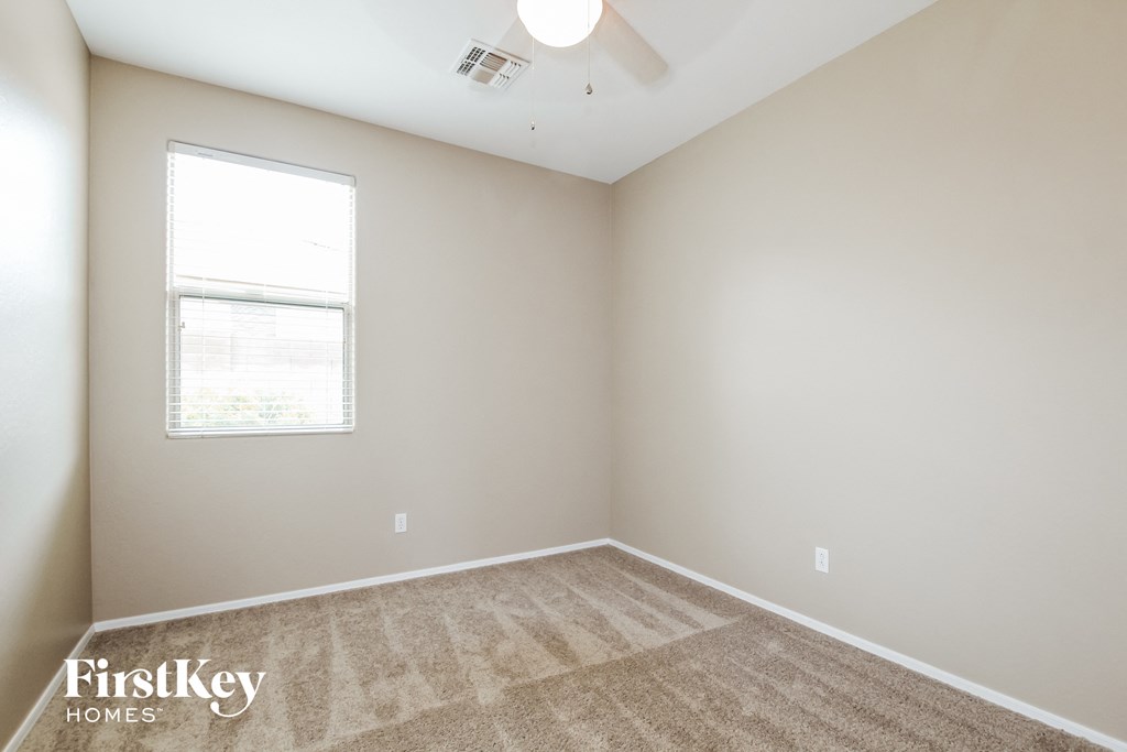 an empty room with carpet and a window