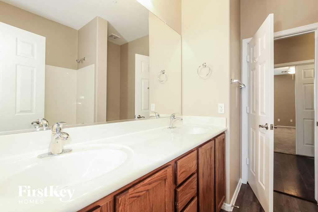a bathroom with two sinks and a large mirror