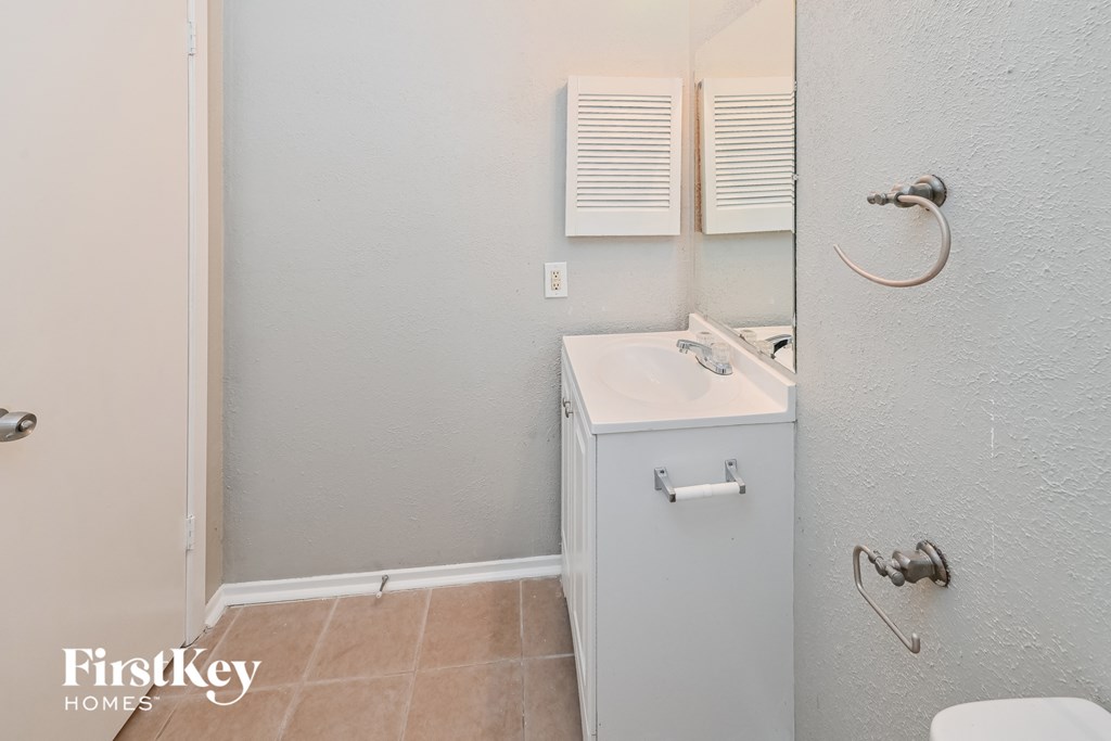 a bathroom with a sink and a toilet and a mirror