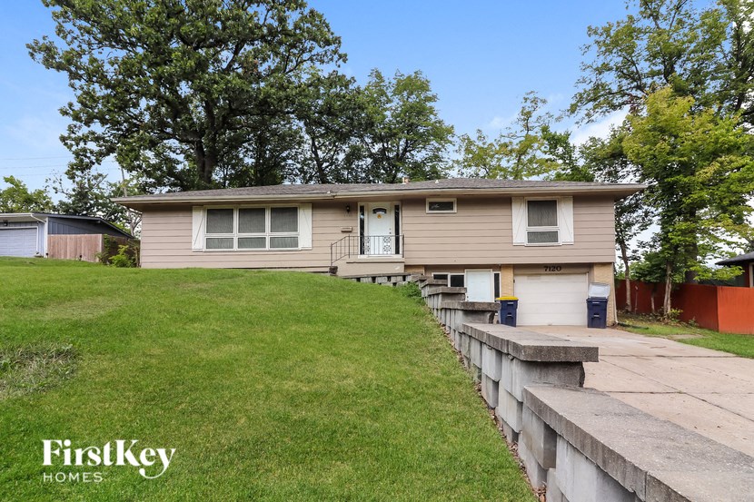 a house on a hill with a retaining wall