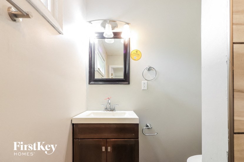 a small bathroom with a sink and a mirror