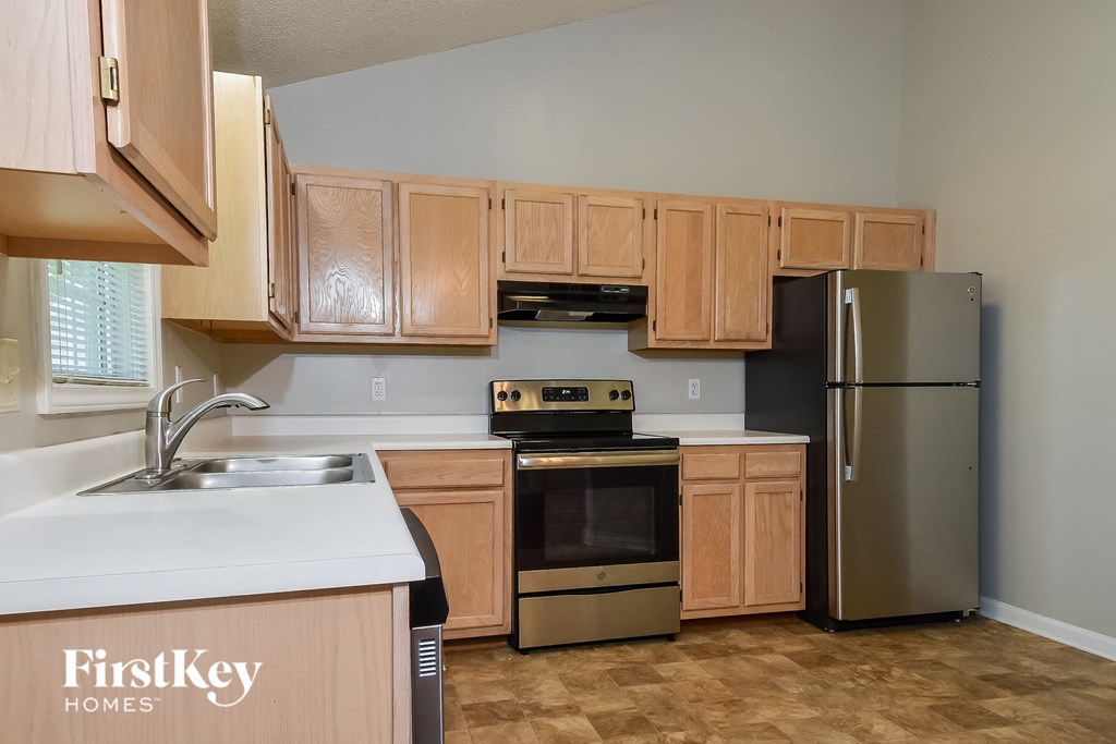 a kitchen with wooden cabinets and stainless steel appliances