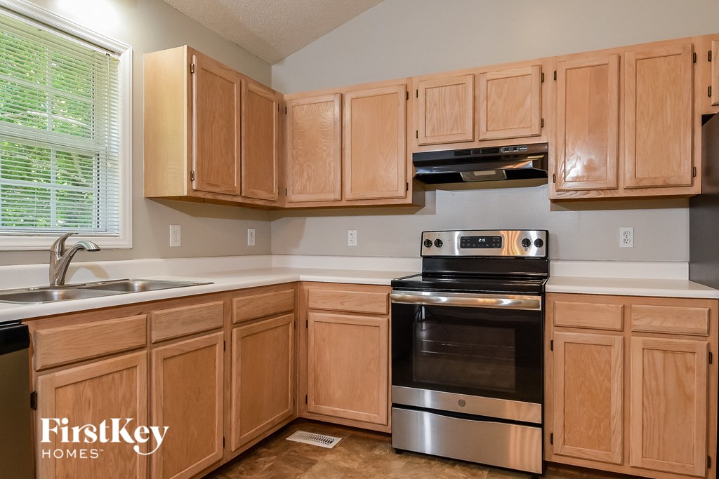 a kitchen with wooden cabinets and stainless steel appliances