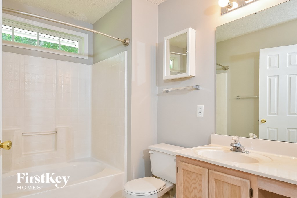 a bathroom with a toilet and a sink and a shower