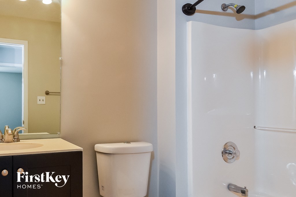 a bathroom with a shower and a sink and a toilet