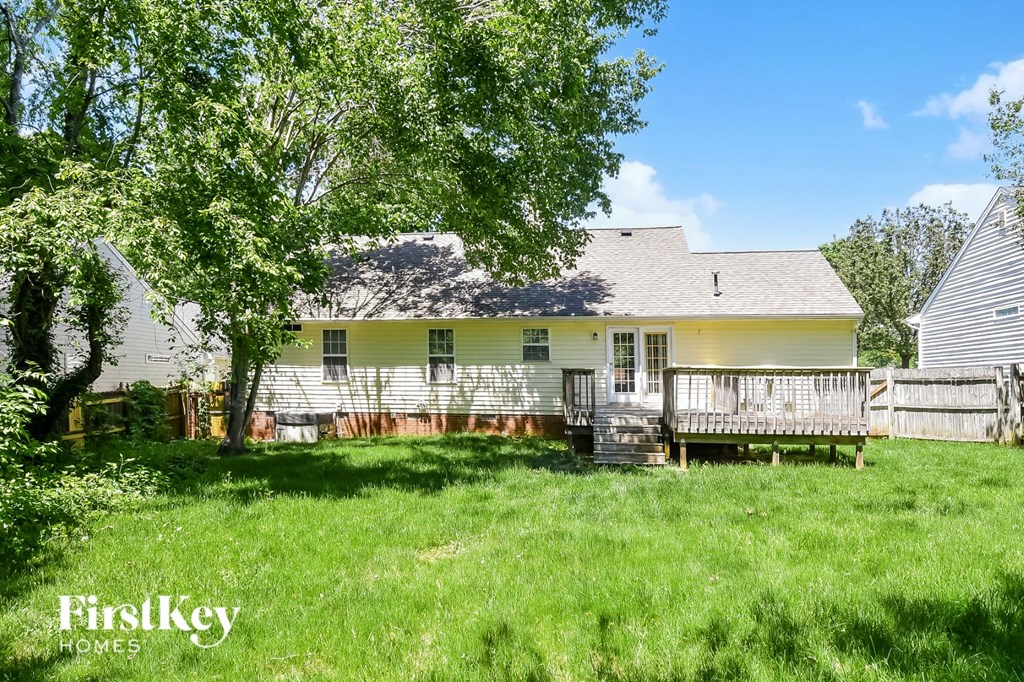 a white house with a yard and a deck