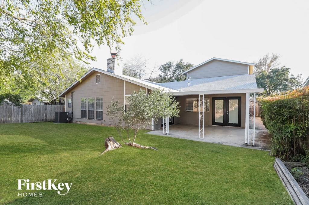 a backyard with a lawn and a house