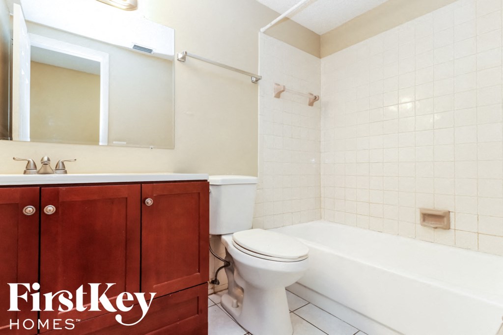 a bathroom with a toilet and a tub and a sink