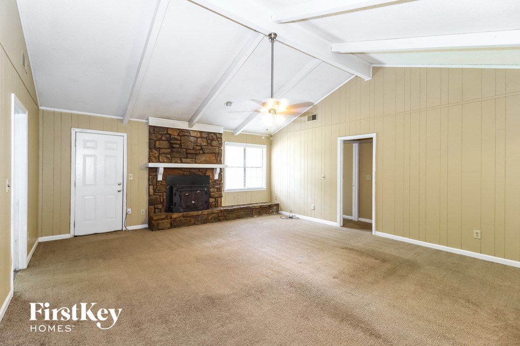 the living room of an empty house with a fireplace