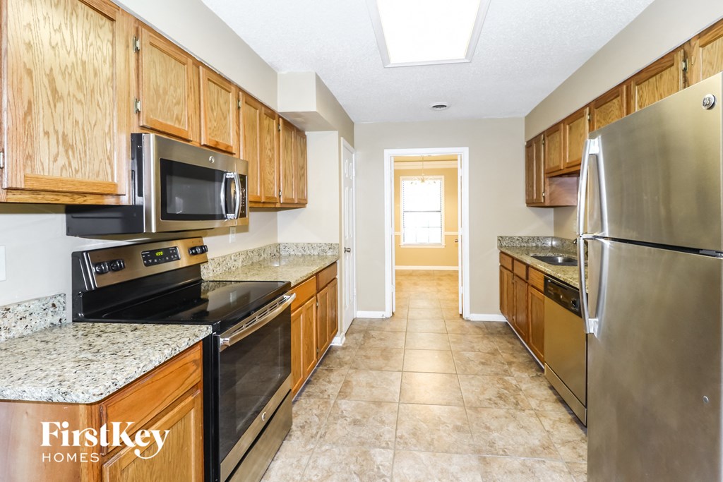 a kitchen with stainless steel appliances and wooden cabinets