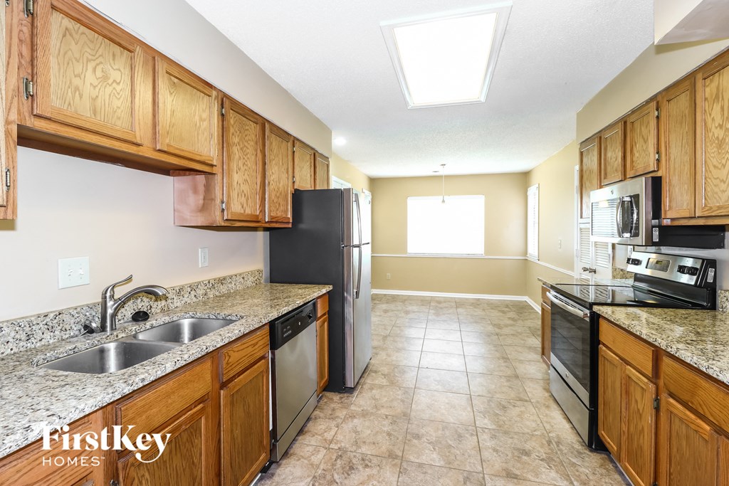 a kitchen with wooden cabinets and a stainless steel refrigerator