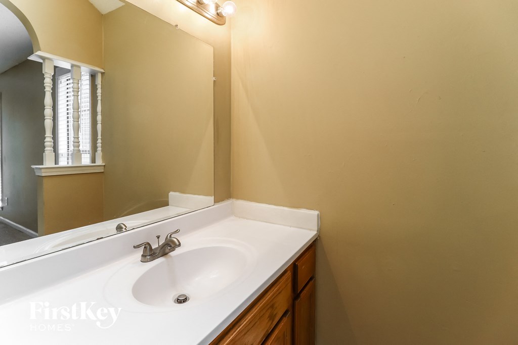 a bathroom with a white sink and a mirror