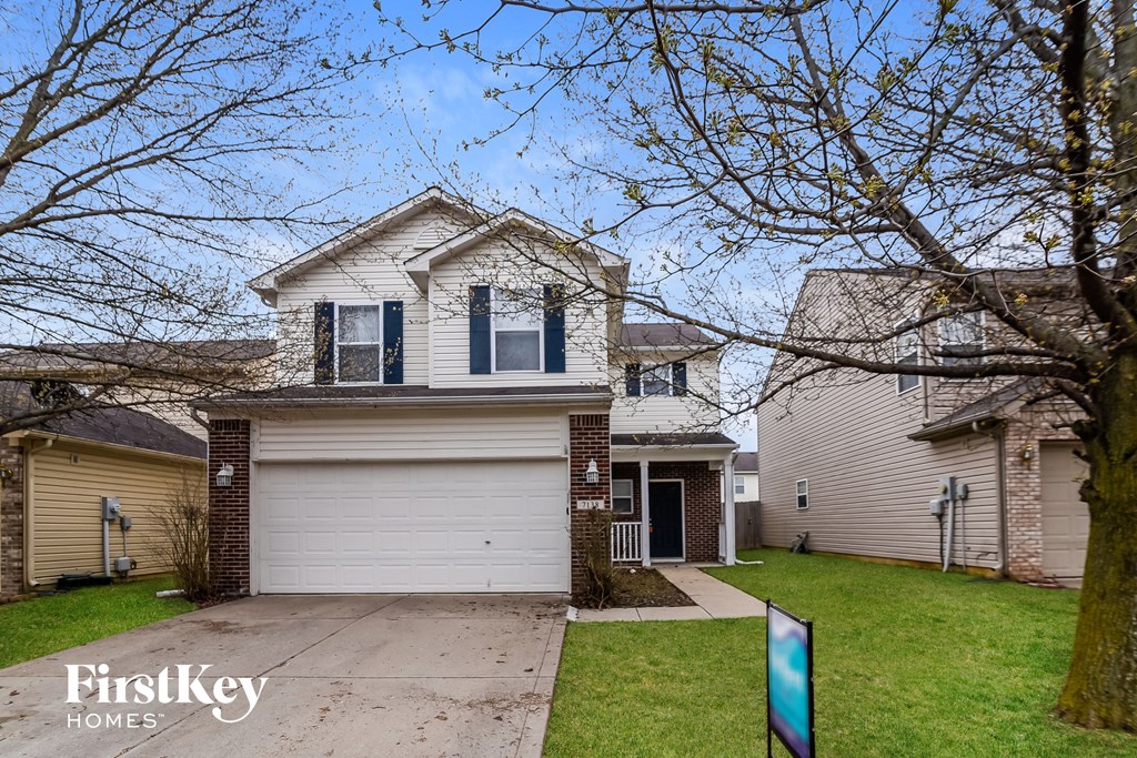 a white garage door in front of a house