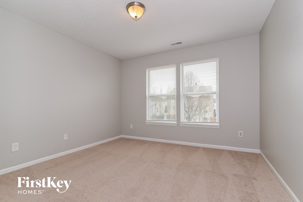 the living room of an empty house with a large window