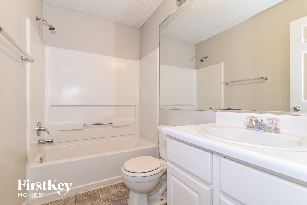 a bathroom with a sink toilet and a bath tub