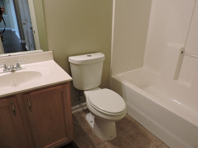 a bathroom with a toilet and a sink and a bath tub