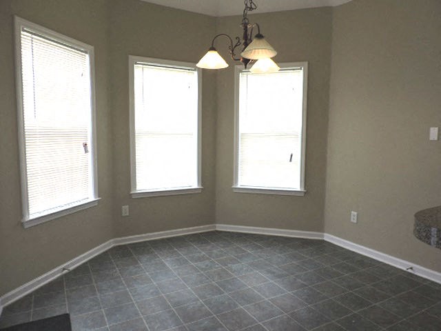 a living room with three windows and a