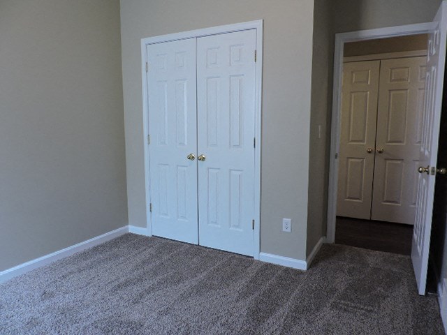 a room with two doors and a carpeted floor