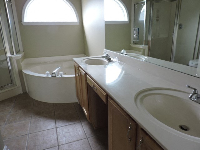 a bathroom with two sinks and a bath tub